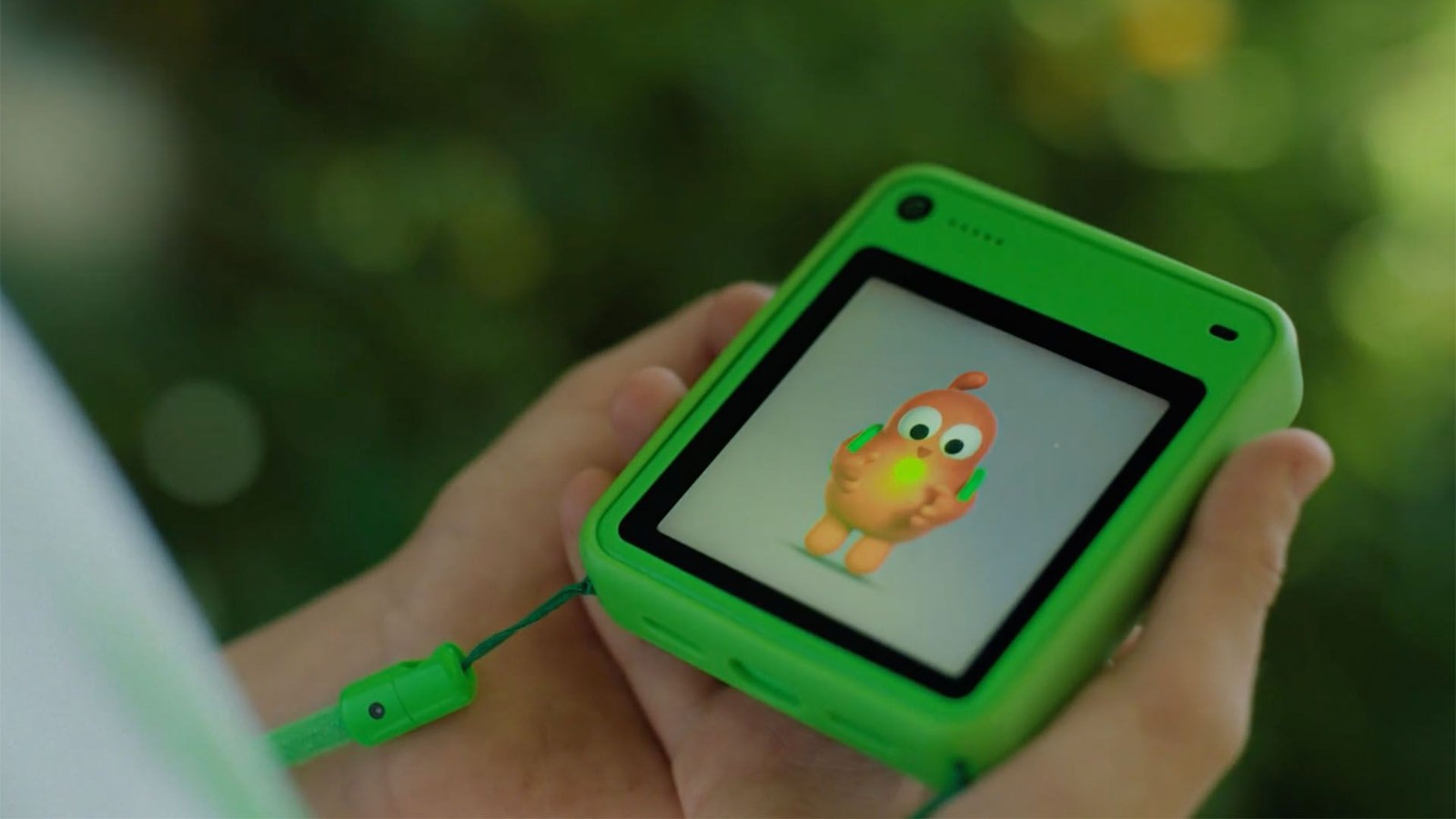 A child holds the green Freckle phone, with a clay character on the ClayOS screen